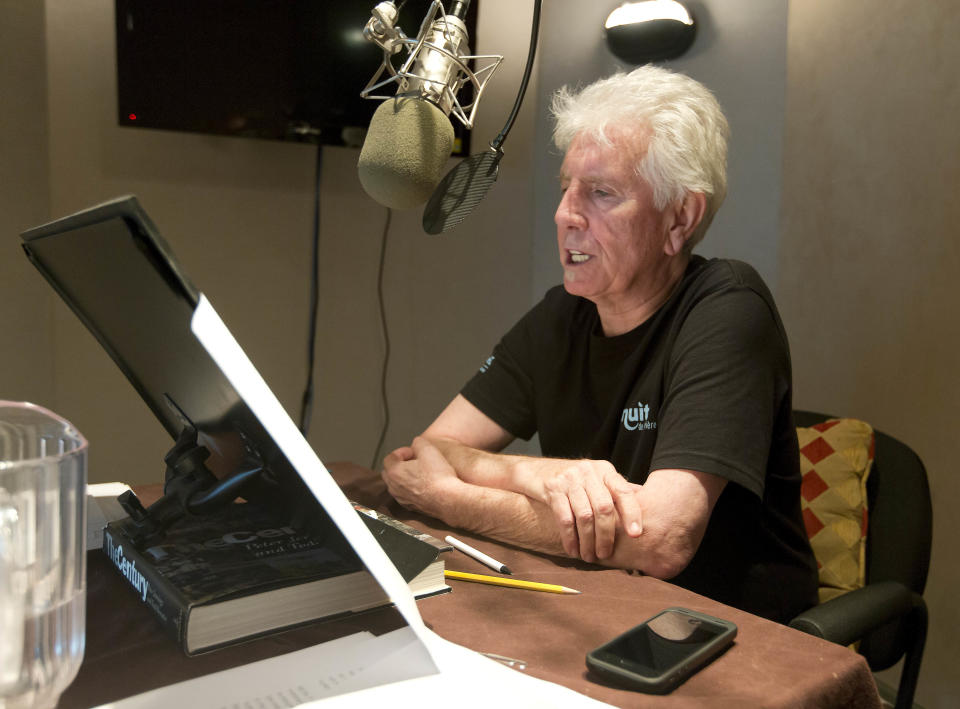 Singer Graham Nash prepares during the recording session for the audio book version of his "Wild Tales: A Rock & Roll Life" autobiography, in New York, Thursday, July 25, 2013. (AP Photo/Richard Drew)