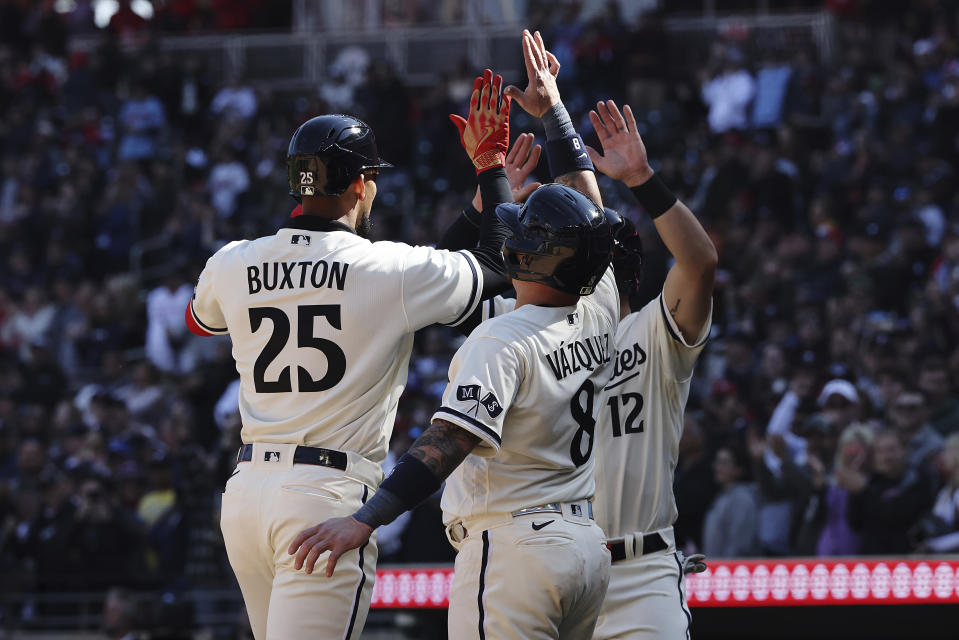 Minnesota Twins' Byron Buxton (25) celebrates with teammates after hitting a homer run during the eighth inning of a baseball game against the Houston Astros, Saturday, April 8, 2023, in Minneapolis. Minnesota won 9-6. (AP Photo/Stacy Bengs)