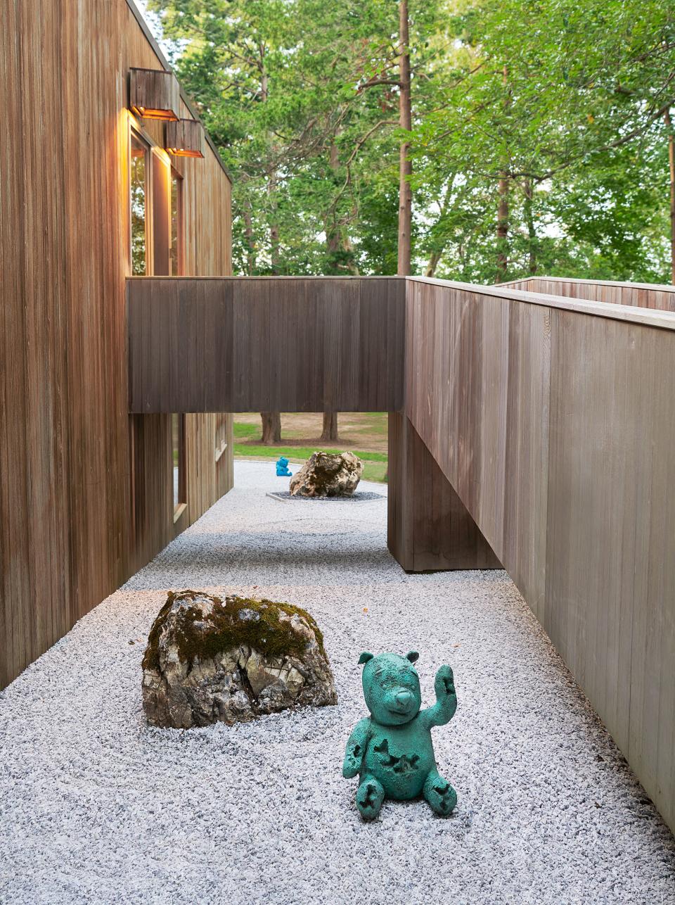 An original Douglas fir ramp leads to the home’s entrance. Green bronze bear by Arsham.