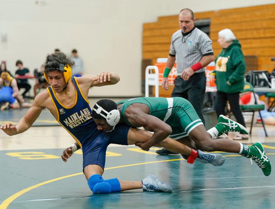Flagler Palm Coast's Toryion Stallings takes down Mainland's Jeremiah Garcia during the Five Star Conference boys wrestling tournament at DeLand High School, Saturday, Feb. 3, 2024.