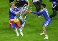 Chelsea's Spanish forward Fernando Torres (L) and Portuguese defender Jose Bosingwa celebrate with the trophy after winning the Champions League final against Bayern Munich on May 19, 2012 at the Allianz Arena stadium in Munich. Chelsea beat Bayern Munich 4-3 on penalties after the game finished 1-1 after extra-time