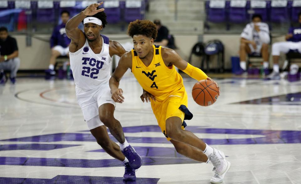 Feb 23, 2021; Fort Worth, Texas, USA; West Virginia Mountaineers guard Miles McBride (4) moves against TCU Horned Frogs guard RJ Nembhard (22) during the second half at Ed and Rae Schollmaier Arena. Mandatory Credit: Tim Heitman-USA TODAY Sports ORG XMIT: IMAGN-446552 ORIG FILE ID:  20210223_gav_sh2_108.jpg