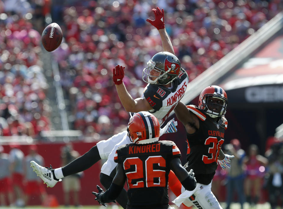 <p>Tampa Bay Buccaneers wide receiver Adam Humphries (10) can[t hang onto a pass as he is hit by Cleveland Browns defensive back Derrick Kindred (26) and defensive back T.J. Carrie (38) during the second half of an NFL football game Sunday, Oct. 21, 2018, in Tampa, Fla. (AP Photo/Mark LoMoglio) </p>