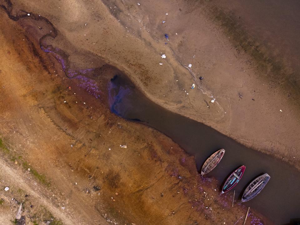 Boats languish over the last pools of water available on the Payagua stream that reaches the Paraguay river amid a historic drought that is affecting its levels, in Chaco-i, Paraguay, Monday, Sept. 20, 2021. (AP Photo/Jorge Saenz)