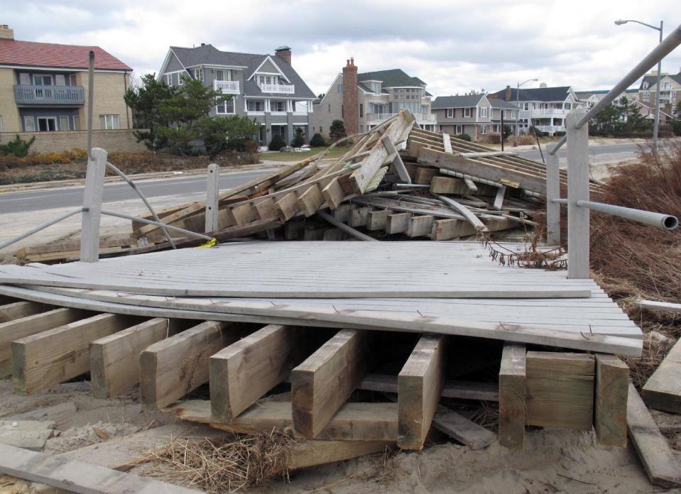 This Nov. 15, 2012 photo shows a section of the Spring Lake N.J. boardwalk that ripped loose during Superstorm Sandy. Spring lake's boardwalk was made of synthetic material. Shore towns are debating whether to use such material, stick with wood, or switch to concrete as they rebuild their boardwalks after the storm. (AP Photo/Wayne Parry)