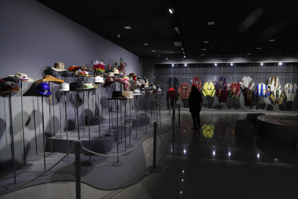 This Sept. 13, 2019 photo shows a collection of hats and ponchos Bolivia's President Eva Morales received as gifts, at the Democratic and Cultural Revolution Museum, in Orinoca, Bolivia. Hundreds of gifts to Morales during his travels around the globe were donated to the museum. (AP Photo/Juan Karita)