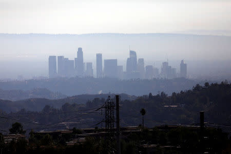 The skyline of downtown Los Angeles is pictured through smoke during the Wilson Fire near Mount Wilson in the Angeles National Forest in Los Angeles, California, U.S. October 17, 2017. REUTERS/Mario Anzuoni