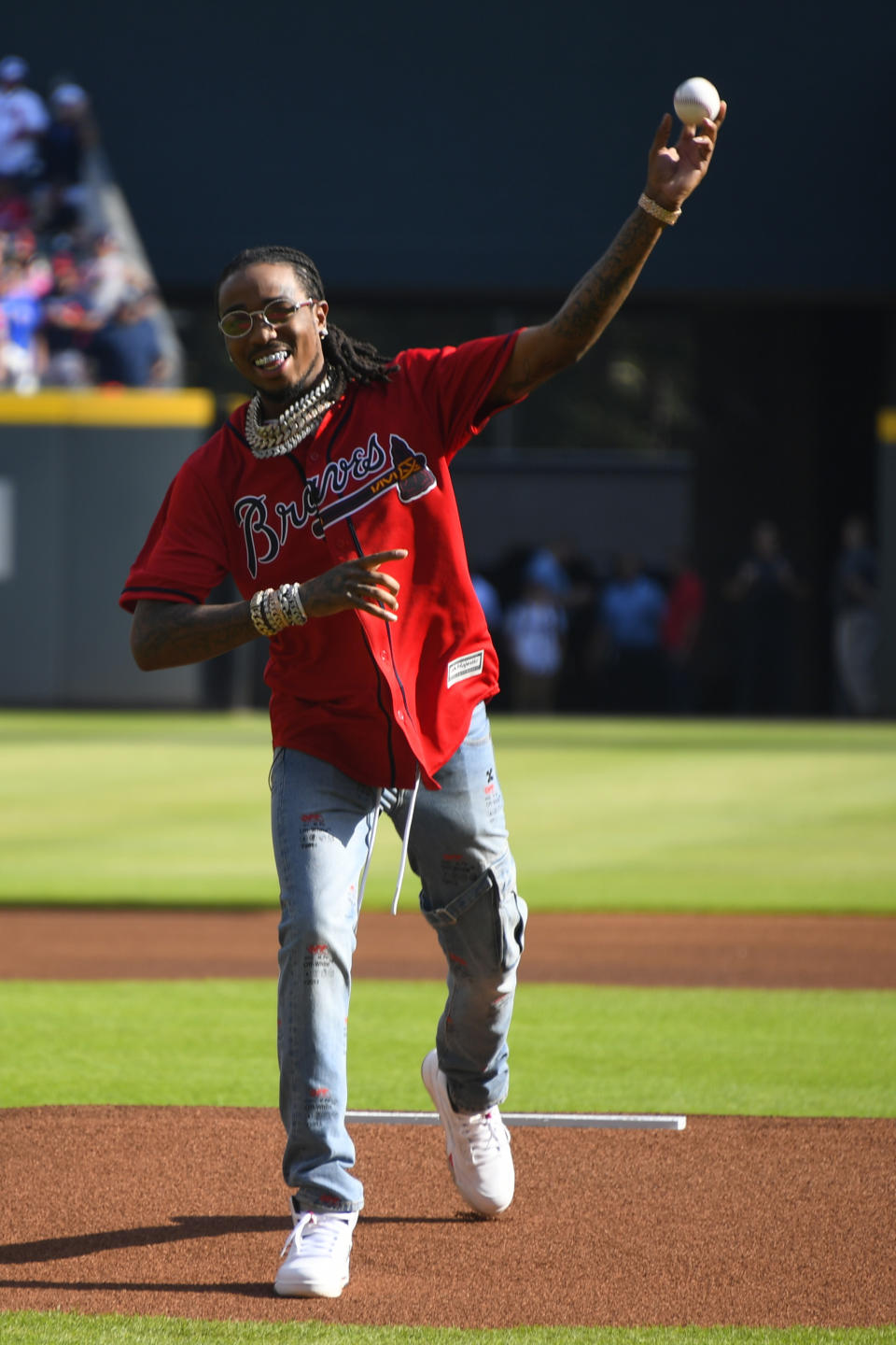 American rapper Quavo, throws the first ceremonial pitch ahead of Game 2 of a best-of-five National League Division Series between the Atlanta Braves and the St. Louis Cardinals, Friday, Oct. 4, 2019, in Atlanta. (AP Photo/John Amis)