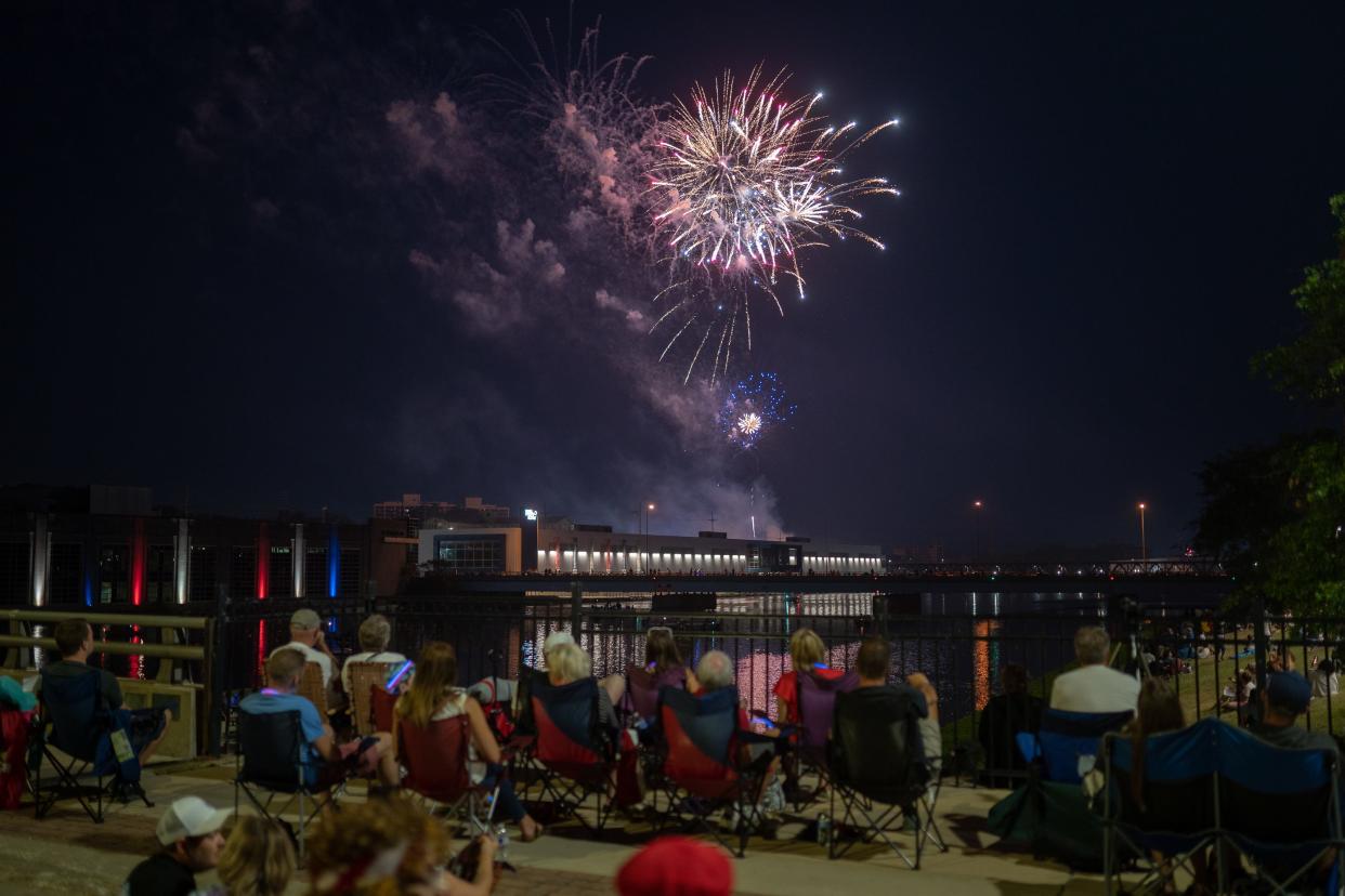 People watch the Fourth of July fireworks show from a popular viewing location — the State Street Bridge — on Sunday, July 4, 2021, in Rockford.