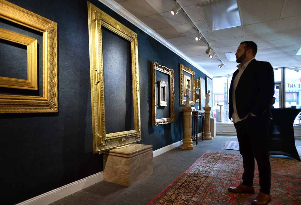 Austin Helmuth stands next to an early 1900's Stanford White frame, valued at $1.4 million. Helmuth Stone Gallery will hold an auction on Jan. 28th of more than 500 period frames from the collection of Eli Wilner.