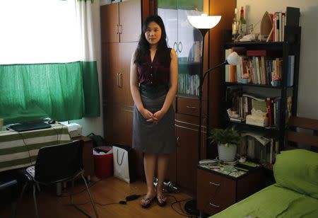 Liu Yun, who was born in 1984, poses for a photograph in Shanghai July 29, 2014. REUTERS/Carlos Barria/Files