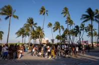 People walk up and down Ocean Drive during Spring Break in Miami Beach, Florida, on Saturday, March 18, 2023.