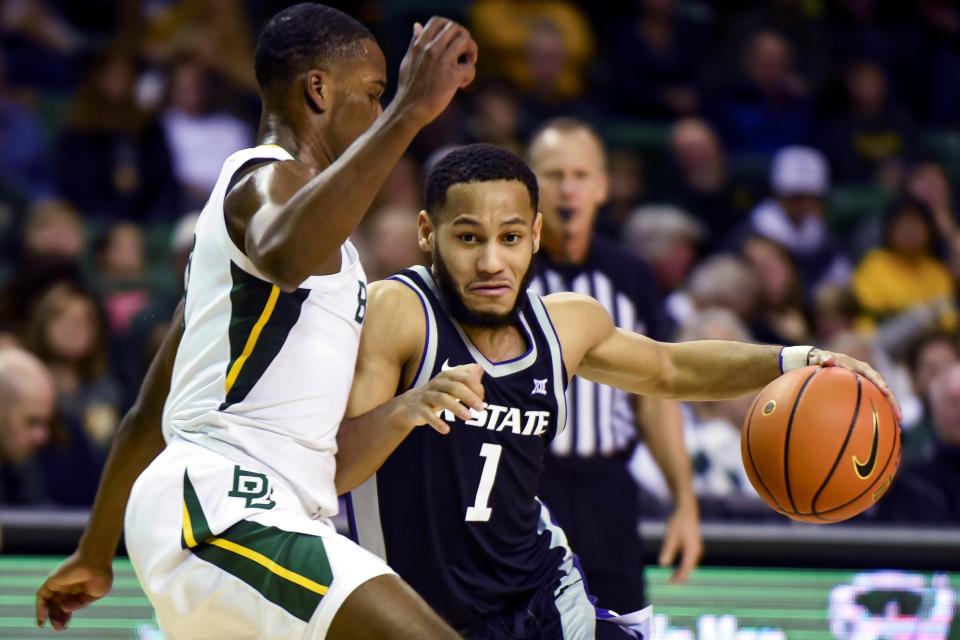 Kansas State guard Markquis Nowell (1) attempts to dribble past Baylor's Dale Bonner (3) in the first half Tuesday night in Waco, Texas.