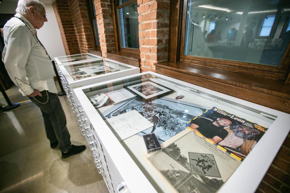 A tour walks through to view exhibits in The Church Studio in Tulsa.