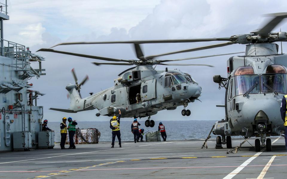 Royal Navy Merlin helicopters operating from the deck of Royal Fleet Auxiliary Argus