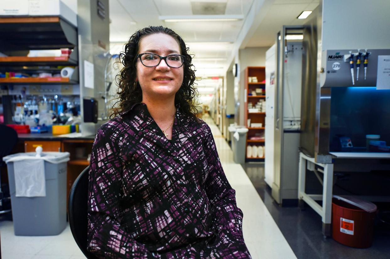 Caryn Bird, seen Thursday in a lab hallway at the Georgia Cancer Center M. Bert Storey Research Building, is a sixth year doctoral student researching cancer immunotherapy.