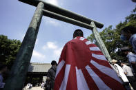 Visitors queue to enter Yasukuni Shrine Saturday, Aug. 15, 2020, in Tokyo. Japan marked the 75th anniversary of the end of World War II. (AP Photo/Eugene Hoshiko)