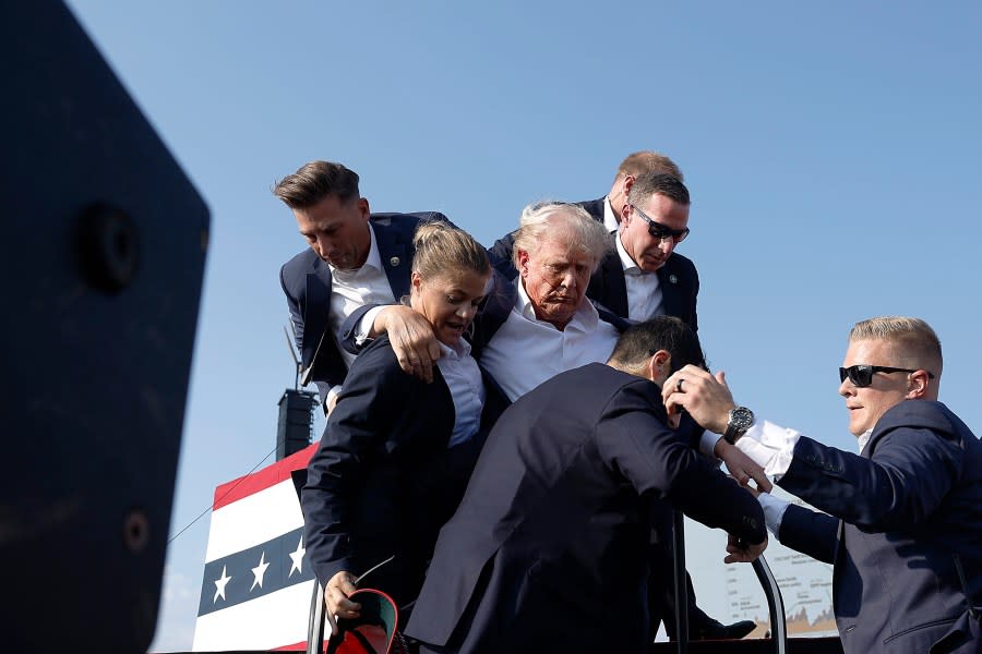 BUTLER, PENNSYLVANIA – JULY 13: Republican presidential candidate former President Donald Trump pumps his fist as he is rushed offstage during a rally on July 13, 2024 in Butler, Pennsylvania. (Photo by Anna Moneymaker/Getty Images)