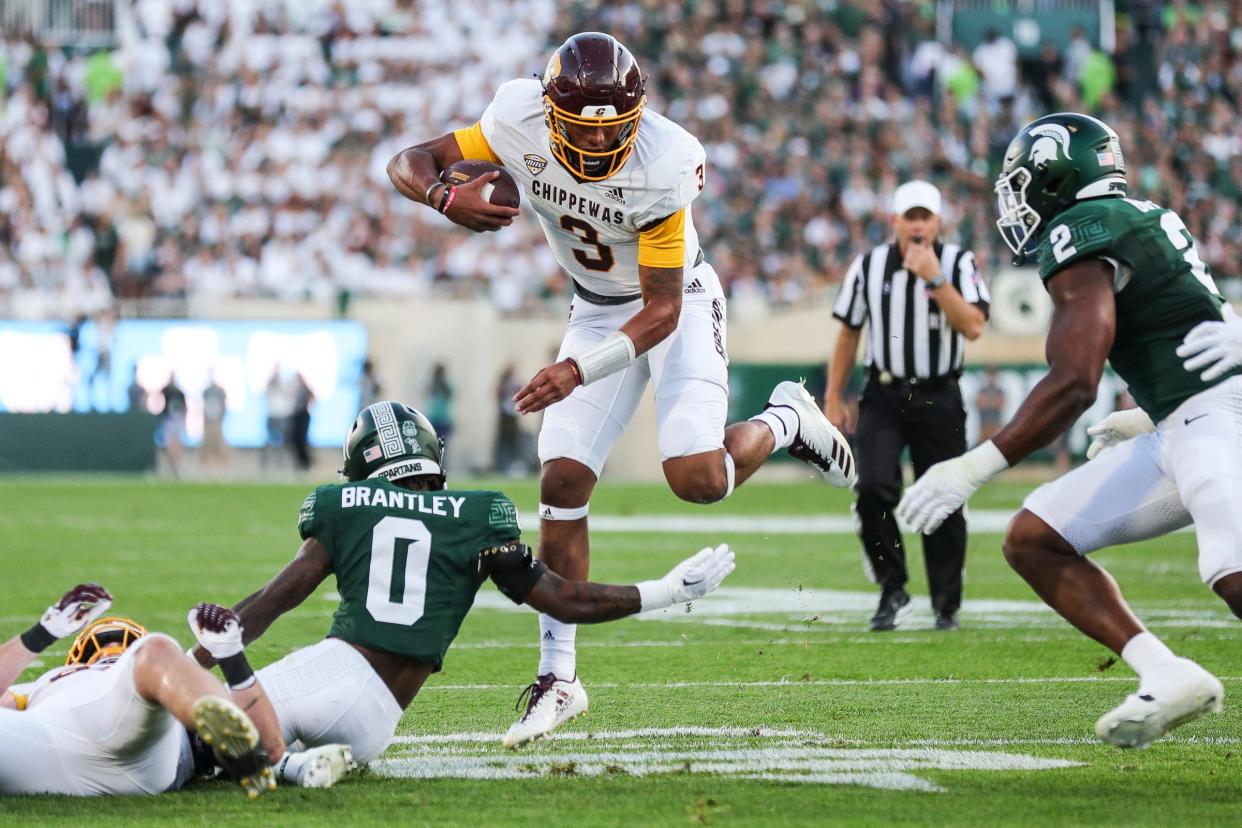 Central Michigan quarterback Bert Emanuel Jr. (3) runs against Michigan State defensive back Charles Brantley (0) during the first half at Spartan Stadium in East Lansing on Friday, Sept. 1, 2023.