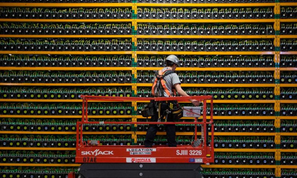 A technician inspects the backside of bitcoin mining at Bitfarms in Saint Hyacinthe, Quebec