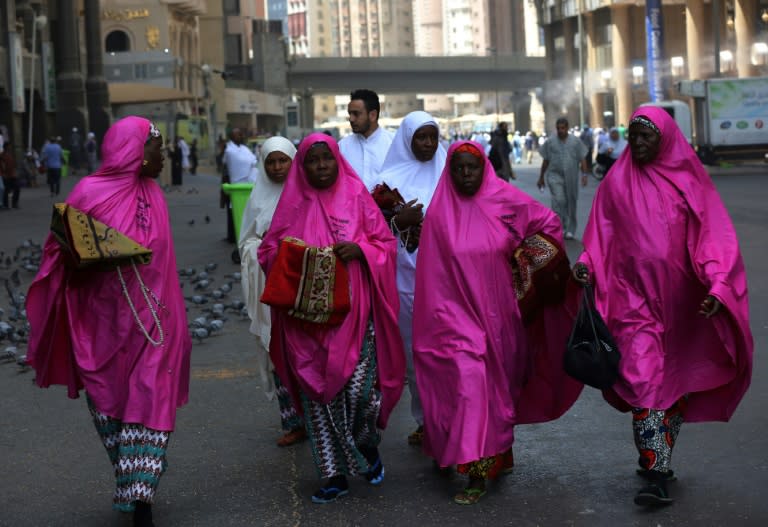 Pilgrims walk outside the Grand Mosque in Saudi Arabia's holy city of Mecca on August 16, 2018