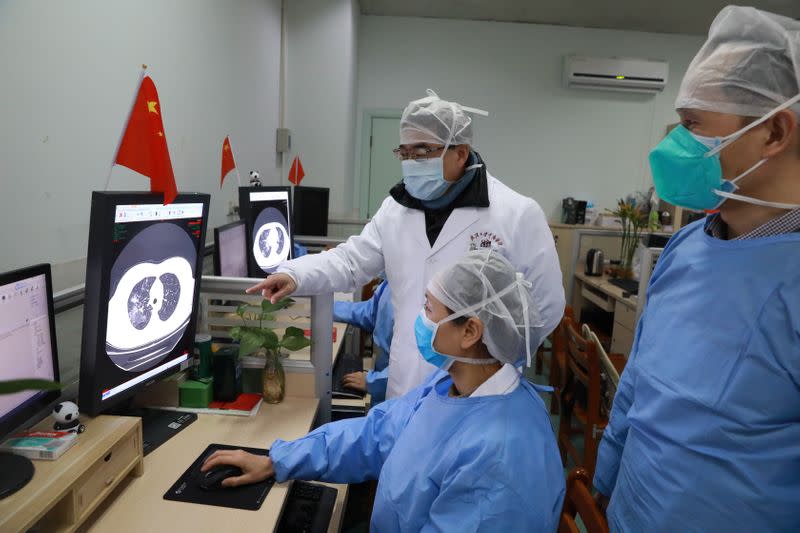 Medical workers inspect the CT scan image of a patient at the Zhongnan Hospital of Wuhan University following an outbreak of the new coronavirus in Wuhan