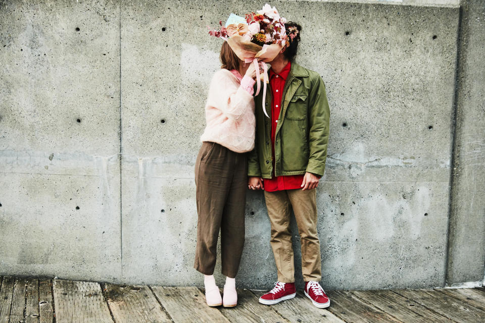 a couple holding up flowers