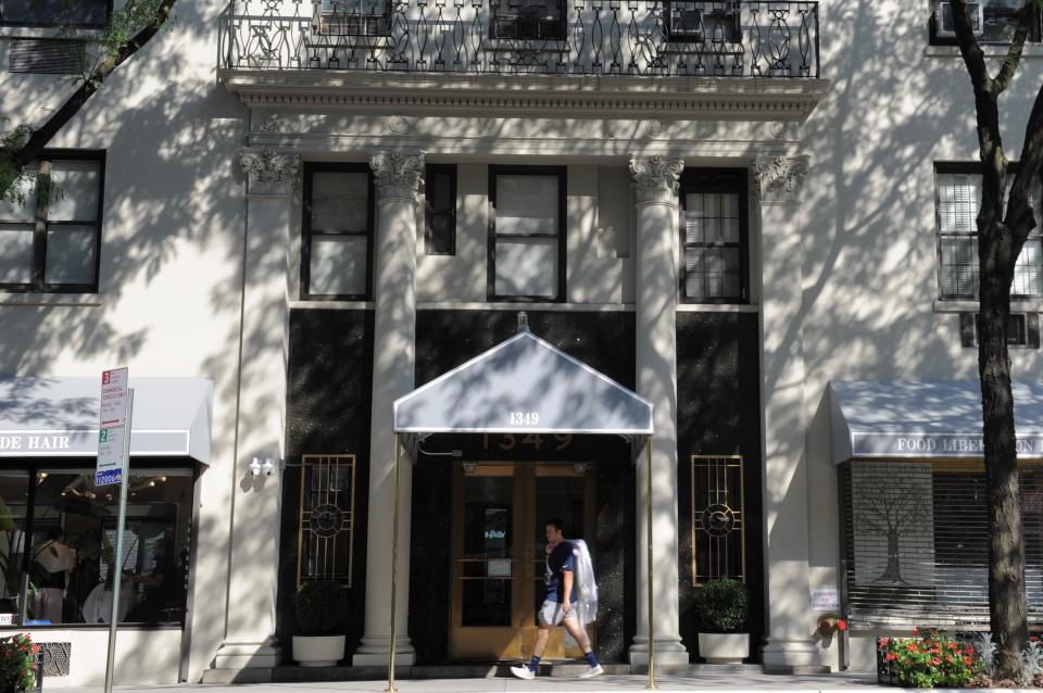 A man walks past a residential building in Manhattan, New York City, the United States, on July 19, 2022.  (Photo by Emma Li/Xinhua via Getty Images) 