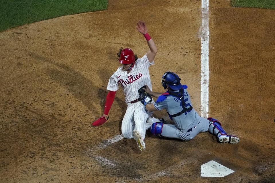 Alec Bohm, left, is tagged out by Austin Barnes while trying to score in the fifth inning