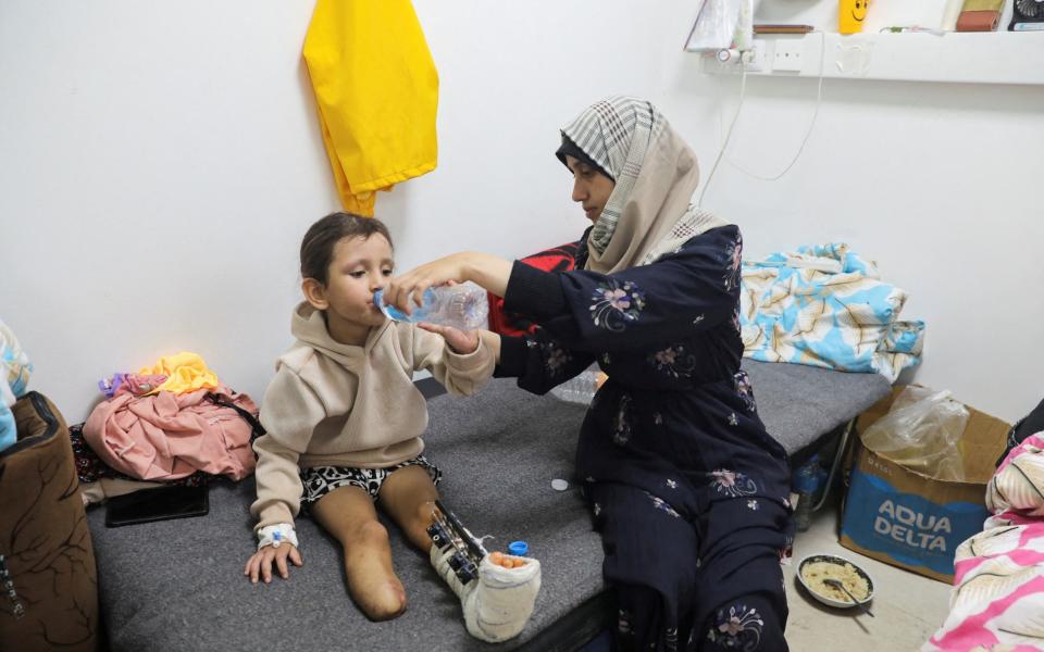 Palestinian girl Eman Al-Kholi, whose limb was amputated after being wounded in an Israeli strike that killed her parents