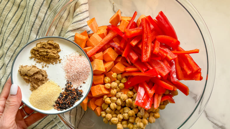 adding spices to the bowl