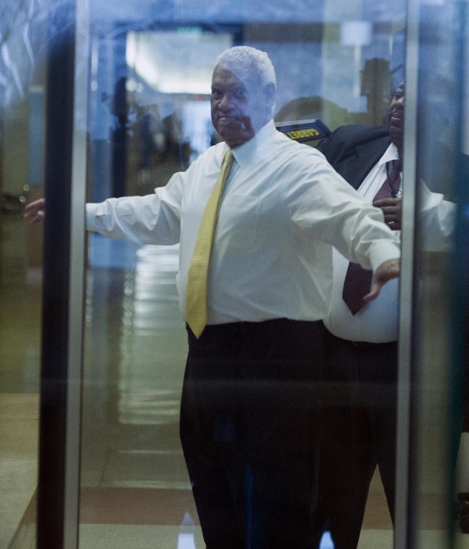 This photo taken through a courthouse window shows Washington businessman Jeffrey Thompson checked by security as he enters the federal courthouse in Washington, Monday, March 10, 2014. Thompson was charged Monday with conspiracy to violate federal and local campaign finance laws by funding off-the-books campaign activity for candidates including Hillary Rodham Clinton and district Mayor Vincent Gray. after being charged this morning in a criminal information with two conspiracy offenses stemming from an ongoing investigation . Thompson is suspected of funneling illicit funds into Mayor Gray's campaign.(AP Photo/Cliff Owen)