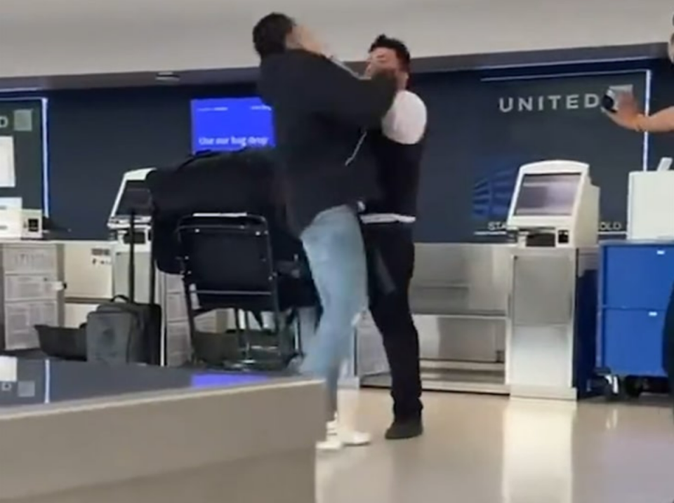 A United Airlines employee and passenger at the Newark International Airport got into a physical altercation caught on camera (Twitter/Screengrab video)