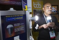 Founder Shailendra Suman poses with a SmartCharge LED lightbulb during "CES Unveiled," a media preview event to the annual Consumer Electronics Show (CES), in Las Vegas, Nevada, January 5, 2014. The bulb, which retails for $25.00, has a rechargeable battery and will give about four hours of light is the power goes out, Suman said. (REUTERS/Steve Marcus)