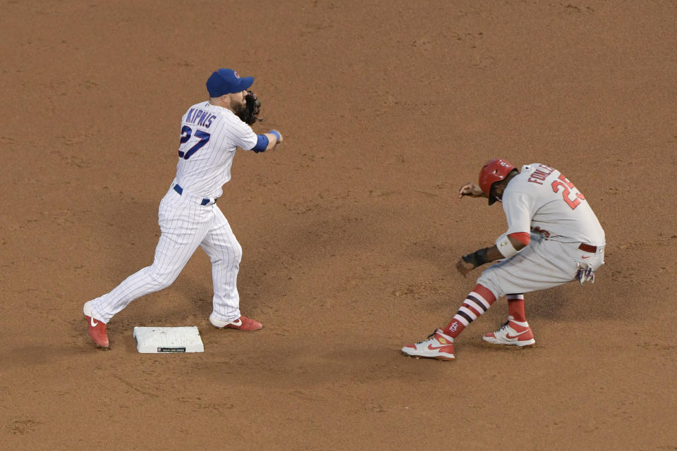 Chicago Cubs second baseman Jason Kipnis (27) turns to finish a double play with a throw over St. Louis Cardinals Dexter Fowler (25) during the second inning of a baseball game Tuesday, Aug. 18, 2020, in Chicago. (AP Photo/Mark Black)