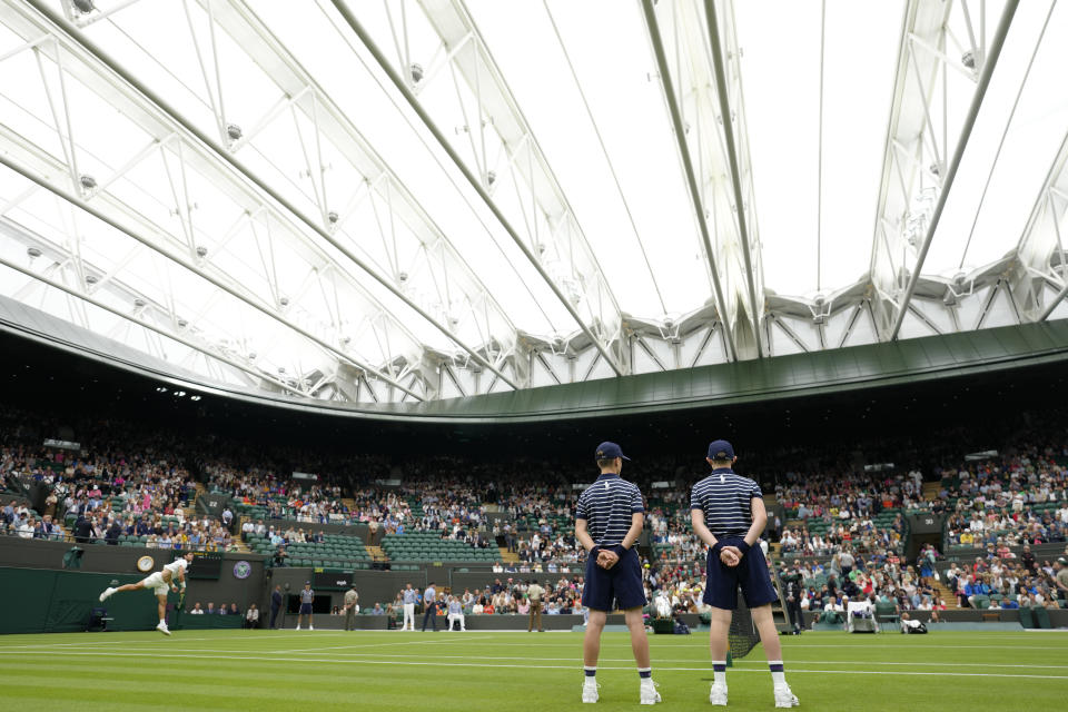 Spain's Carlos Alcaraz serves to Jeremy Chardy of France in a first round men's singles match under the roof on Centre Court on day two of the Wimbledon tennis championships in London, Tuesday, July 4, 2023. (AP Photo/Kirsty Wigglesworth)