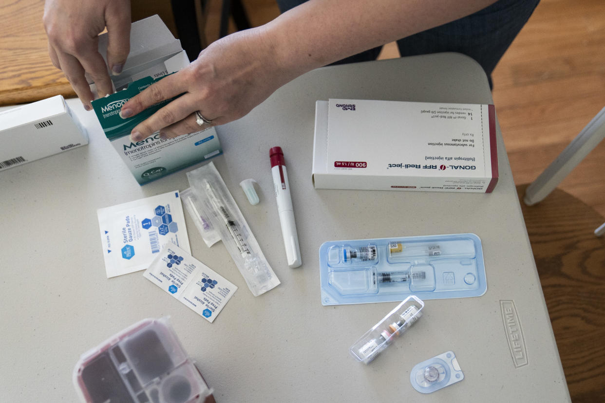 Nina Osborne goes through her IVF medications at home in Parkville, Md.