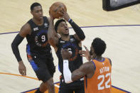 New York Knicks guard Elfrid Payton (6) shoots over Phoenix Suns center Deandre Ayton (22) during the first half of an NBA basketball game, Friday, May 7, 2021, in Phoenix. (AP Photo/Rick Scuteri)