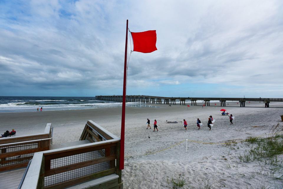 Red flags at beach access points in Jacksonville Beach warn beachgoers of hazardous surf conditions Monday, November 7, 2022