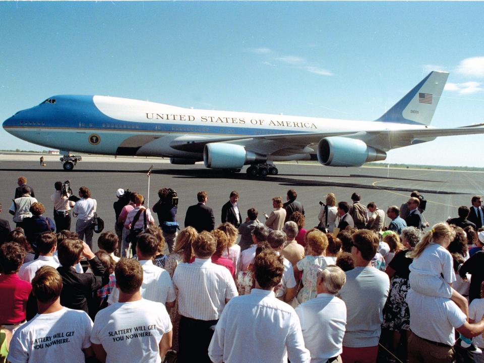 A crowd of people stand on the tarmac of theTopeka airport as the new United States Air Force One presidential aircraft taxis up in Topeka, Kansas, Thursday, Sept. 6, 1990. The Boeing 747, assembled in Kansas, made its maiden voyage with President George Bush on board as he travels to the Midwest for a political fundraising event.