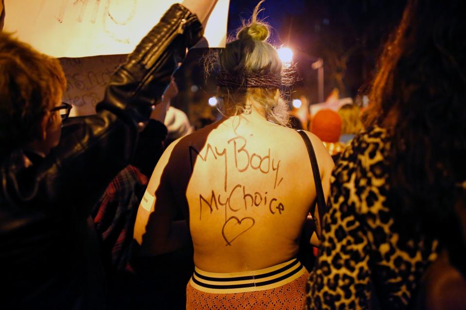 A woman with a slogan written on her back is seen during an International Women's Strike Rally on March 8, 2017, in New York City.