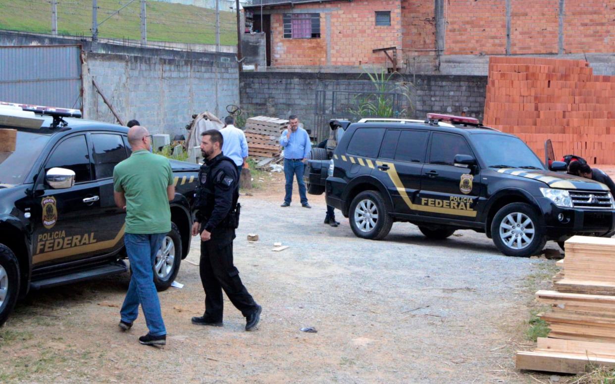 Police inspect the vehicles that were dumped by suspects involved the heist - AP