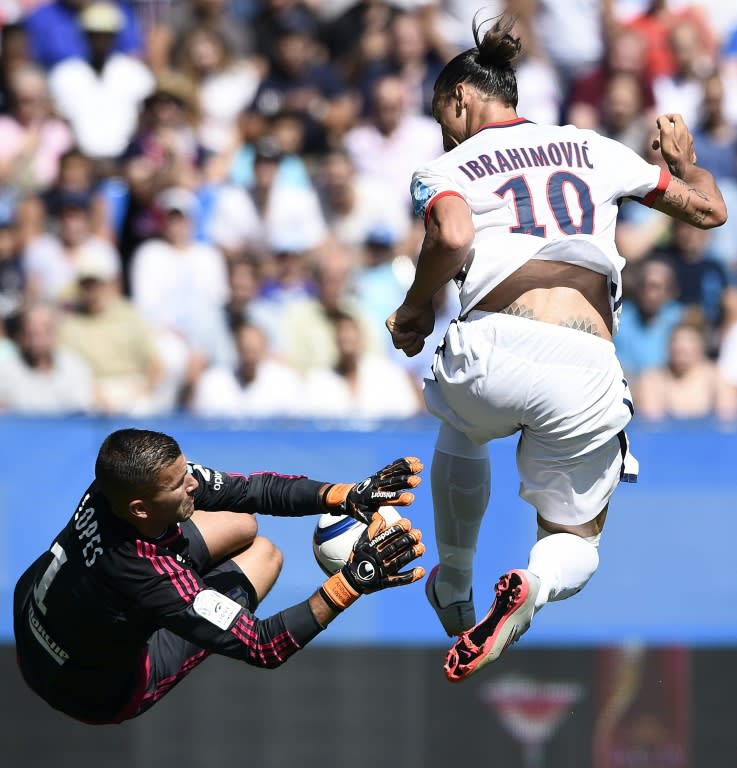 Paris Saint-Germain's Swedish forward Zlatan Ibrahimovic (R) vies with Lyon's French Portuguese goalkeeper Anthony Lopes during the French Trophy of Champions football match at Saputo stadium in Montreal on August 1, 2015