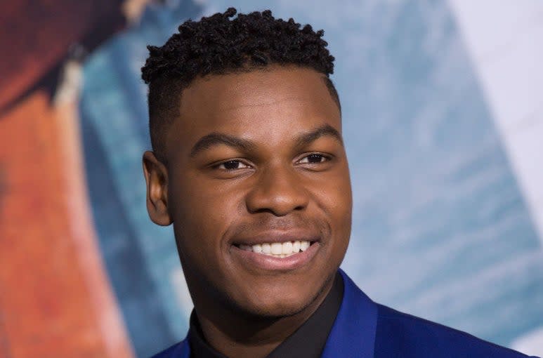John Boyega, smiling, arrives at Universal's "Pacific Rim Uprising" premiere at TCL Chinese Theatre