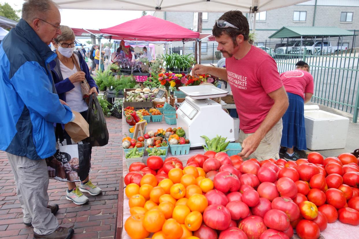 Gary Steiner, one of the owners of Bee-utiful Farm and Garden in Hendersonville, sells tomatoes and other produce at the Hendersonville Farmers Market Tomato Day in 2021.