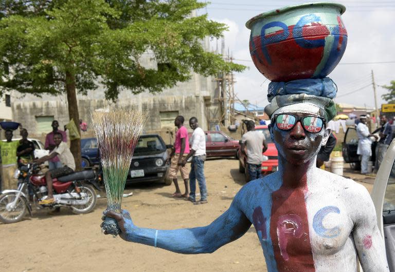 A man wears glasses and body paint adorned with the logo of Nigeria's main opposition All Progressives Congress (APC) as residents await results of the presidential election in Abuja, on March 30, 2015