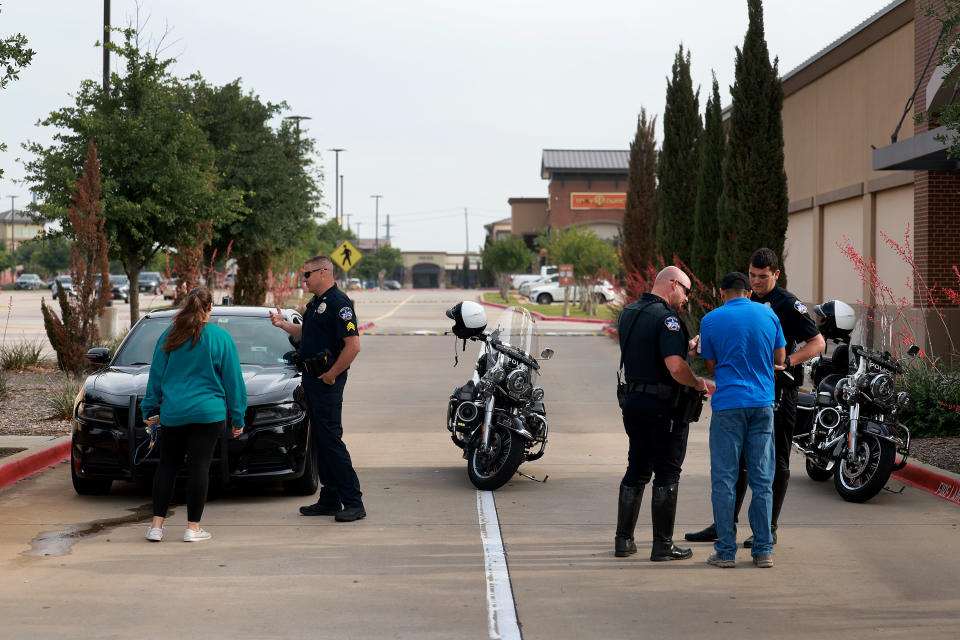 ALLEN, TEXAS - MAY 08:  City of Allen police officers direct people to where they can try to recover their vehicles from the parking lot  of the Allen Premium Outlets mall after the mass shooting occurred on May 8, 2023 in Allen, Texas. On May 6th, a shooter opened fire at the outlet mall, killing eight people. The gunman was then killed by an Allen Police officer responding to an unrelated call. (Photo by Joe Raedle/Getty Images)