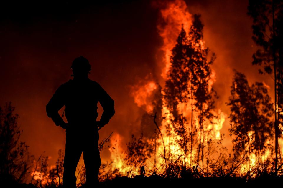 A firefighter monitors the progression of a wildfire at Amendoa in Macao, central Portugal on July 21, 2019. (Photo: Patricia De Melo Moreira/AFP/Getty Images)