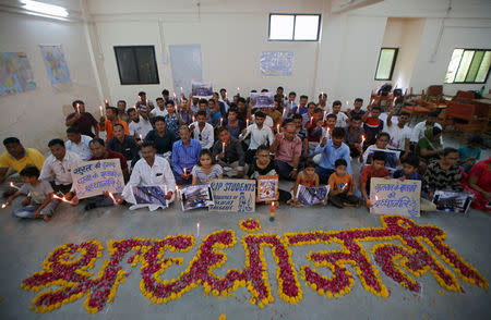 People attend a prayer meet to pay tribute to the victims of a fire that broke out in a commercial building in the western city of Surat on Friday, inside a library in Ahmedabad, India, May 25, 2019. REUTERS/Amit Dave