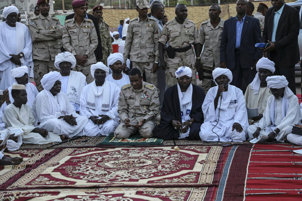 In this Saturday, May 18, 2019 photo, Gen. Mohammed Hamdan Dagalo, better known as Hemedti, kneeling center, the deputy head of the military council that assumed power in Sudan after the overthrow of President Omar al-Bashir, prays during a Ramadan event, in Khartoum, Sudan. Dagalo says he refused orders from al-Bashir to fire on the protesters, and he praised them as recently as last weekend. Many likely see him as an ally against the Islamic movement that orchestrated al-Bashir’s 1989 coup and underpinned his regime. (AP Photo)